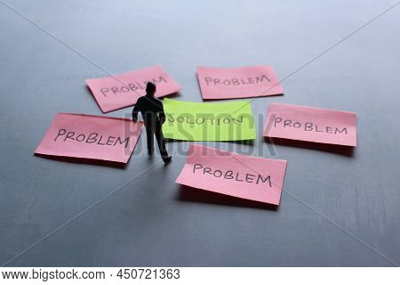 Business Solutions, Problem Solving And Brainstorming Concept. Miniature Man Looking At Red Paper Wi
