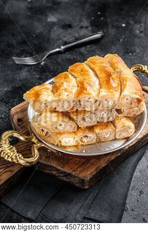 Traditional Feta Cheese Phyllo Pastry Pie In Rustic Skillet. Black Background. Top View