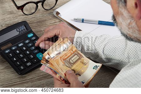 Personal Finance Management, Accounting Concept. The Man Performs Calculations Of Arithmetic Operati