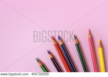 Color Pencils On A Light Pink Background. Top View With Space For Text. Back To School Concept. Flat