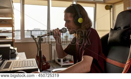 Male Singer Singing Song In Microphone And Recording It At Home Studio. Domestic Hobby, Entertainmen
