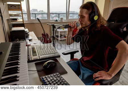 Male Singer Singing In Microphone And Recording His Voice At Home Studio. Concept Of Domestic Hobby,