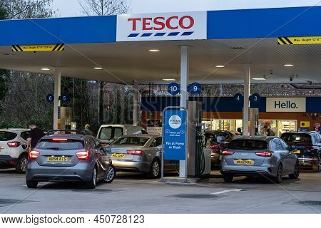 Wigan, Uk: March 10, 2022: Queuing Cars Waiting To Buy Fuel At A Tesco Petrol Filling Station As Bri