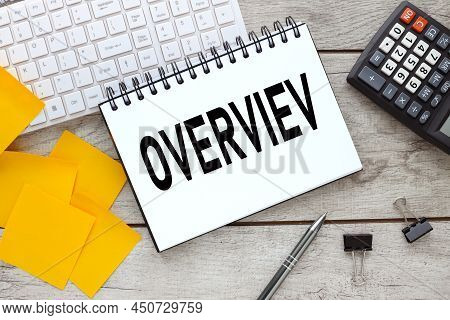 Overview . Work Desk With White Keyboard. Text On Notebook