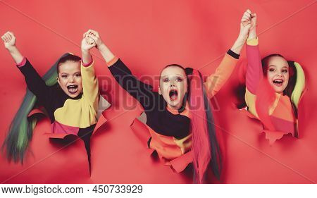 Back To Party. Cute Industrious Children Are Breaking Through Color Paper Wall. Kids Holding Hands H
