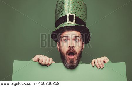 Green Patricks Background. Man In Saint Patricks Day Leprechaun Party Hat Having Fun On Green Backgr