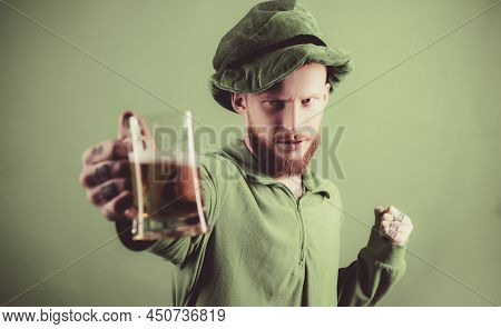 Man On Green Background Celebrate St Patricks Day. Portrait Of Excited Man Holding Glass Of Beer On 