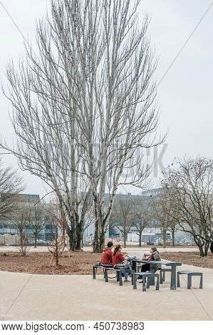 Strasbourg, France - Mar 21, 2015: Students Taking A Pause Eating At The Steel Outdoor Furniture Tab