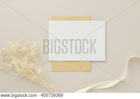 Blank Greeting Card Invitation Mockup 5x7 On Brown Envelope With Dried Flowers On Beige Background, 