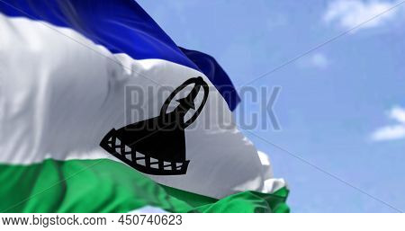 Detail Of The National Flag Of Lesotho Waving In The Wind On A Clear Day. Lesotho Is An Enclaved Cou