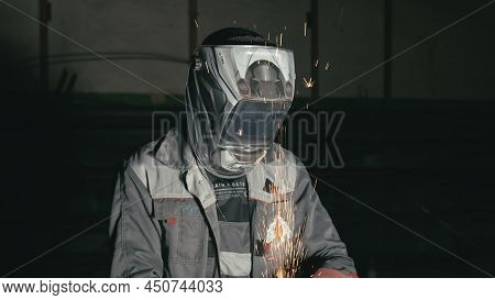 Russia, Irkutsk - June 21, 2019: Smithy Manual Production. Industrial Worker Using Angle Grinder And