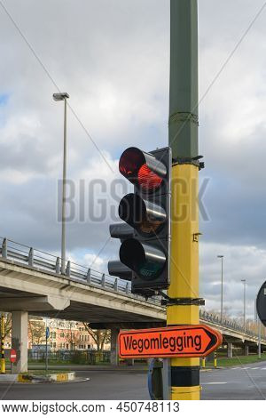Road Sign Of The Bypass Direction Of The Road Wegomlegging -inscription In Dutch. Traffic Light With