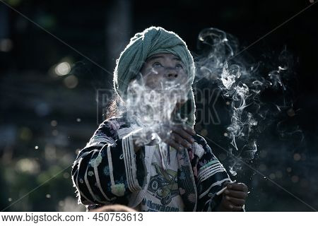 Chiang Mai, Thailand - December 21, 2010: An Elder Lahu Tribe Woman In Traditional Clothing Smoking 