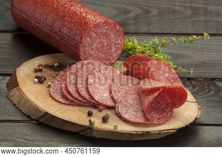 Italian Type Pork Salami On A Dark Set(whole And Slices)