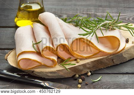 Slices Of Smoked Turkey Filet On A Wooden Board(horizontal)