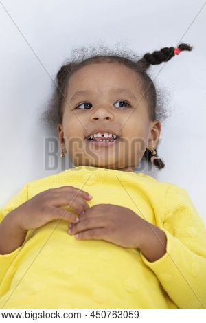 Portrait Of A Funny Little African American Girl With Pigtails.