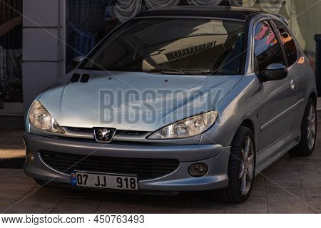 Side, Turkey - February 20 2022:   Silver  Peugeot 208  Is Parked  On The Street On A Warm Summer Da