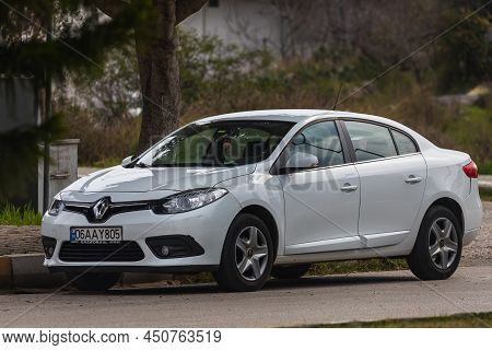 Side, Turkey - February 20 2022:  Swhite Renault Fluence   Is Parked  On The Street On A Warm Summer
