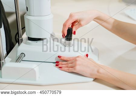 Doctor Examines Eyes On Screen Of Autorefractometer.