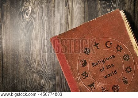 Detail Of Science Of World Religions Book On Wooden Table. Top View.