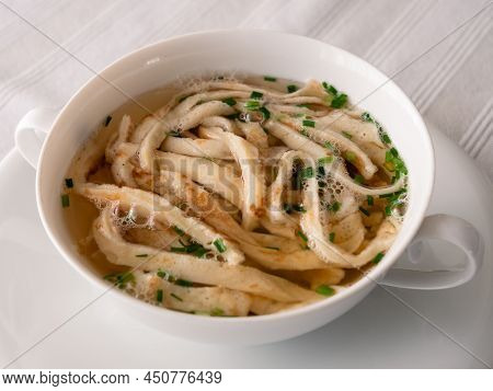 Austrian Sliced Pancake Soup Or Frittatensuppe With Chives, A Clear Beef Broth