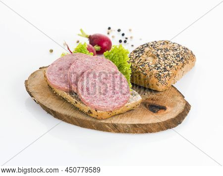 A Sandwich Of Turkey Meat Salami On A Wooden Board