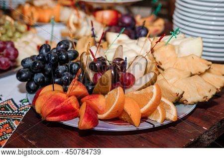 Fruit Slicing At A Wedding Banquet. Watermelon, Grapes, Strawberry, Orange, Plum, Pear, Dinha, Peach