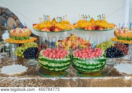 Fruit Slicing At A Wedding Banquet. Watermelon, Grapes, Strawberry, Orange, Plum, Pear, Dinha, Peach