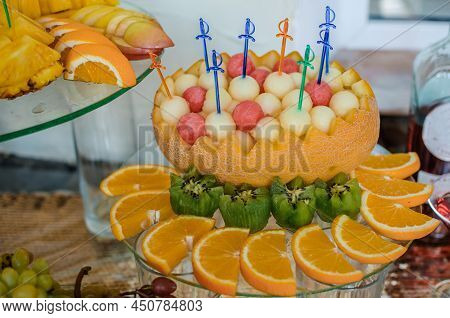 Fruit Slicing At A Wedding Banquet. Watermelon, Grapes, Strawberry, Orange, Plum, Pear, Dinha, Peach