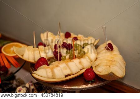 Fruit Slicing At A Wedding Banquet. Watermelon, Grapes, Strawberry, Orange, Plum, Pear, Dinha, Peach