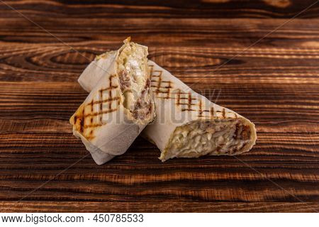 Shawarma Rolled Sandwich With Sauce And Vegetables, Arab Traditional Food. Shawarma Doner Kebab Wrap