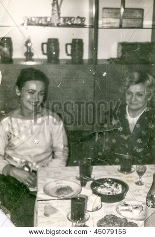 Vintage photo of aunt and adult niece during a family party, seventies