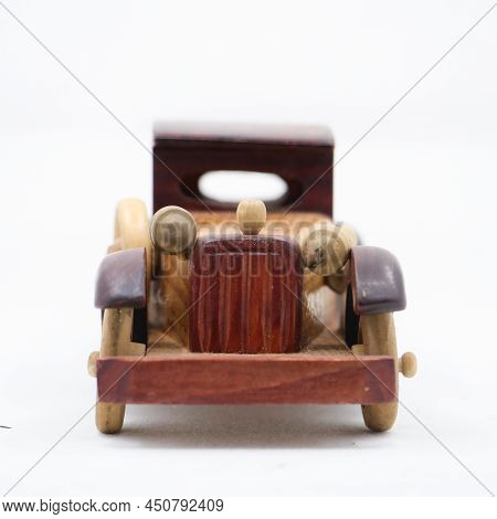 Front View Of An Vintage Model Brown Wooden Toy Car Isolated In A White Background
