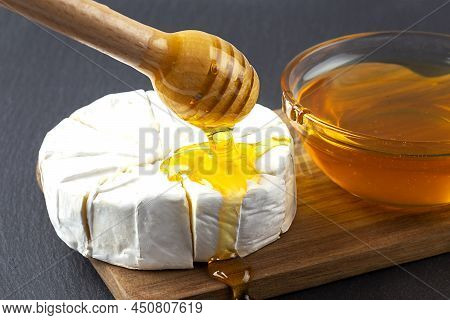 Camamber Cheese And Honey On Black Background.
