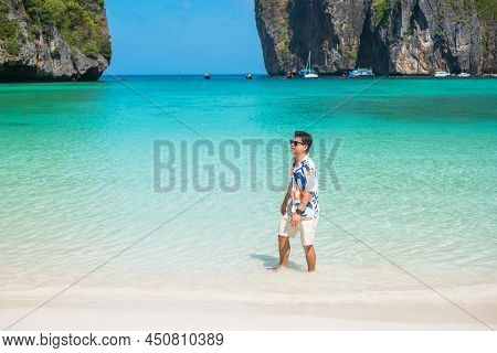 Happy Tourist Man At Maya Bay Beach On Phi Phi Island, Krabi, Thailand. Landmark, Destination Southe