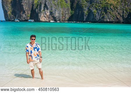 Happy Tourist Man At Maya Bay Beach On Phi Phi Island, Krabi, Thailand. Landmark, Destination Southe