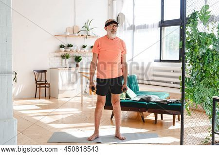 Elderly Aged Male Exercising With Dumbbells During Online Training. Old Person Man Pensioner Healthy