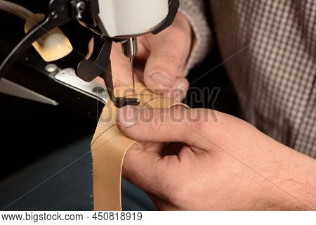 Industrial Sewing Machine In Workshop Of Shoemaker. Bootmaker Setting Up Professional Sewing Equipme
