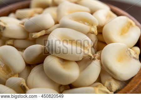Whole Dried Hominy. Dry Maize Mote Grain In Wooden Bowl
