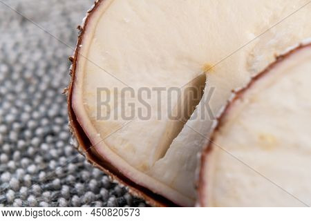 Cassava Yucca Root With Crack Close Up On Rustic Rough Jute. Macro. Sliced Raw Manioc