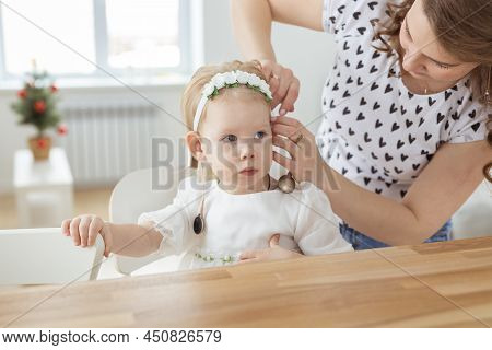 Mother Helps To Put On Cochlear Implant For Her Deaf Little Daughter. Hearing Aid And Deafness Conce