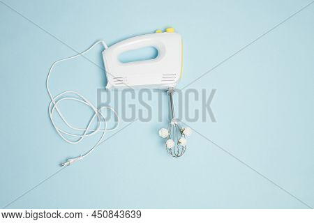 Creative Concept Made Of White Electric Hand Mixer With Beaters, Cabel And White Rose Flowers On Pas