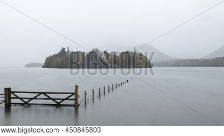 Beautiful Long Exposure Landscape Image Of Derwentwater Looking Towards Catbells Peak In Autumn Duri
