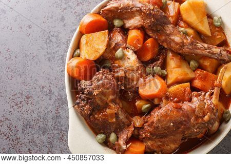Rabbit Stew Maltese Style Or Stuffat Tal-fenek Closeup In The Pan On The Table. Horizontal Top View 