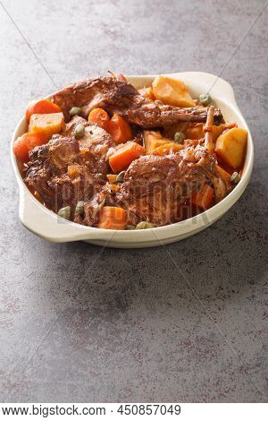 Traditional Malta National Dish Stewed Rabbit Stuffat Tal-fenek Closeup In The Pan On The Table. Ver