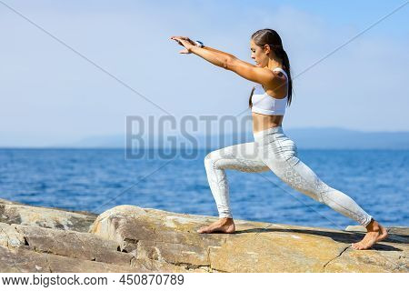 Female Athlete Practicing Yoga Streching Workout Outdoors By The Sea