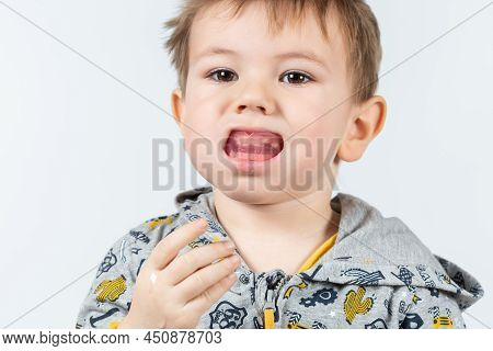 Cute Caucasian Boy Shows Myofunctional Trainer. Dental Tariner Is Made To Help Equalize The Growing 