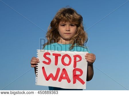 Child Protest Against War. Portrait Boy Calls To Stop War, Raises Banner With Inscription Stop The W