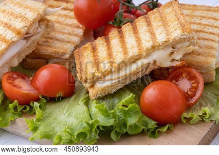 Tasty Club Sandwiches With Ham And Cheese On Wooden Table. Grilled And Pressed Toast With Smoked Ham