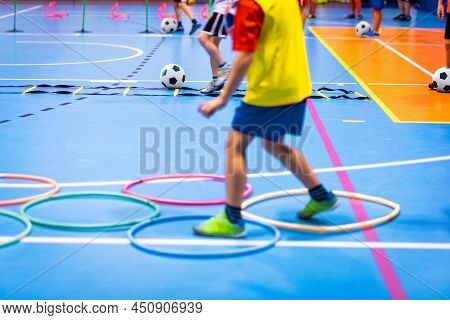 Indoor Soccer Class For Kids At School Sports Hall. Children Kicking Soccer Balls On Wooden Futsal F